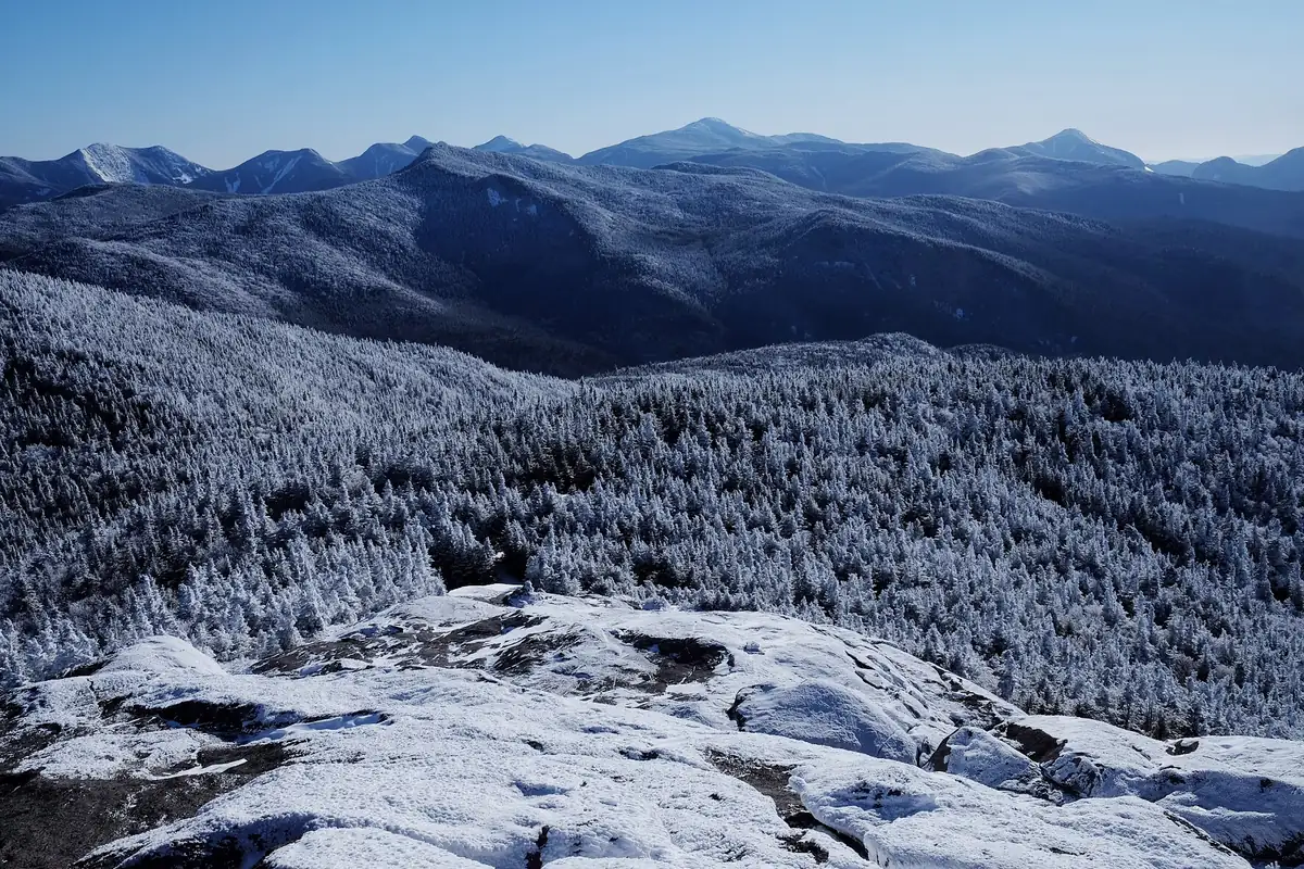 Snowshoe hikers on a winter trail in the Adirondack Mountains - Adirondack Mountains | KnowOutdoor