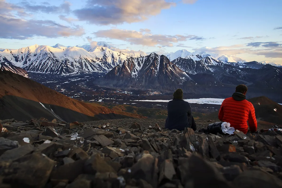 Backpackers eating on open ground in the Denali backcountry - Alaska Range | KnowOutdoor