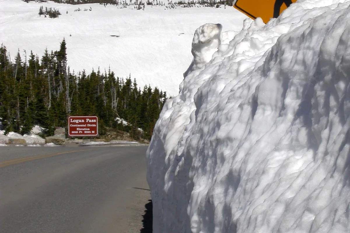 Deep roadside snowbank below a mountain pass - Summer snow | KnowOutdoor