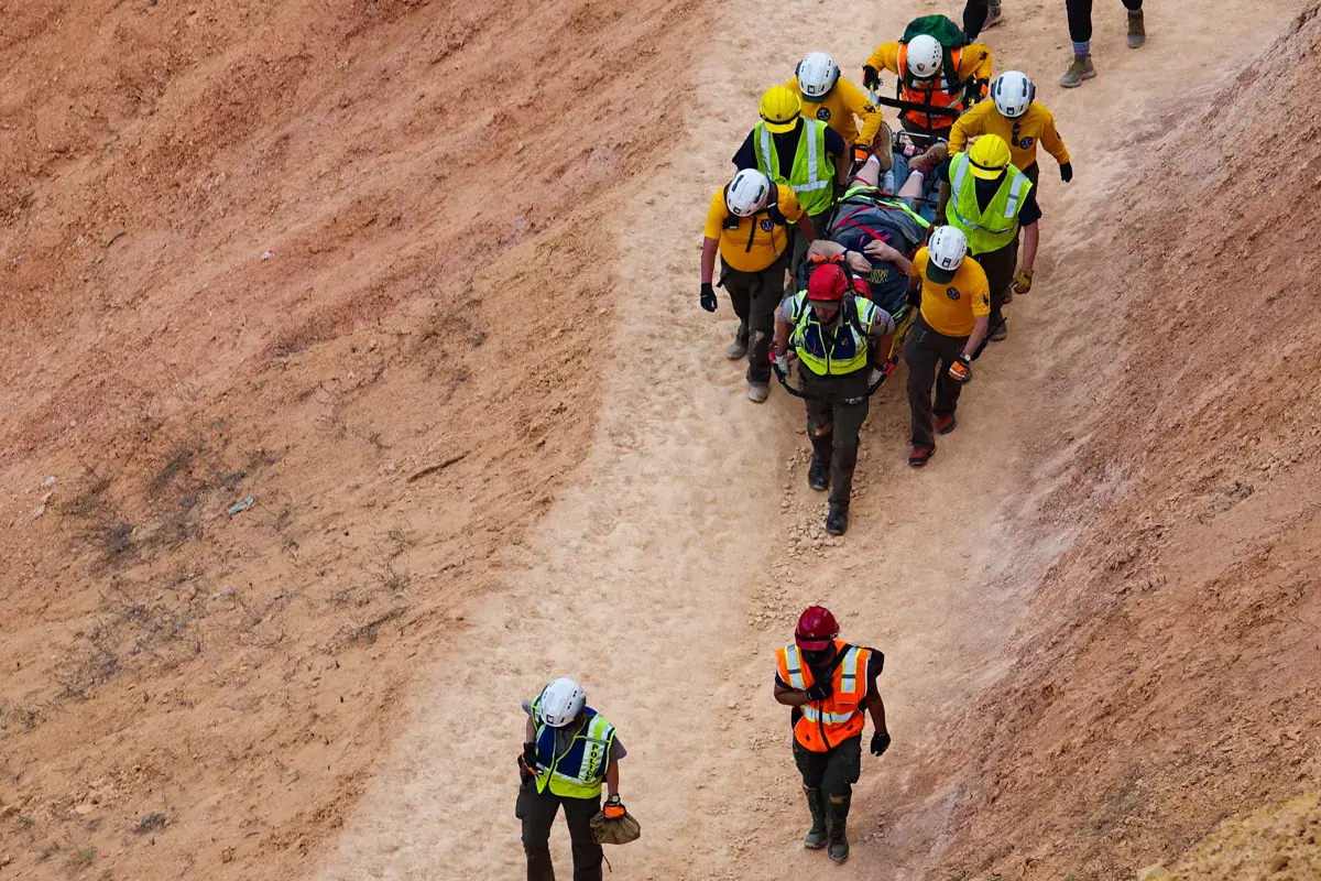 Rescue team moving a patient uphill on a steep Bryce Canyon trail