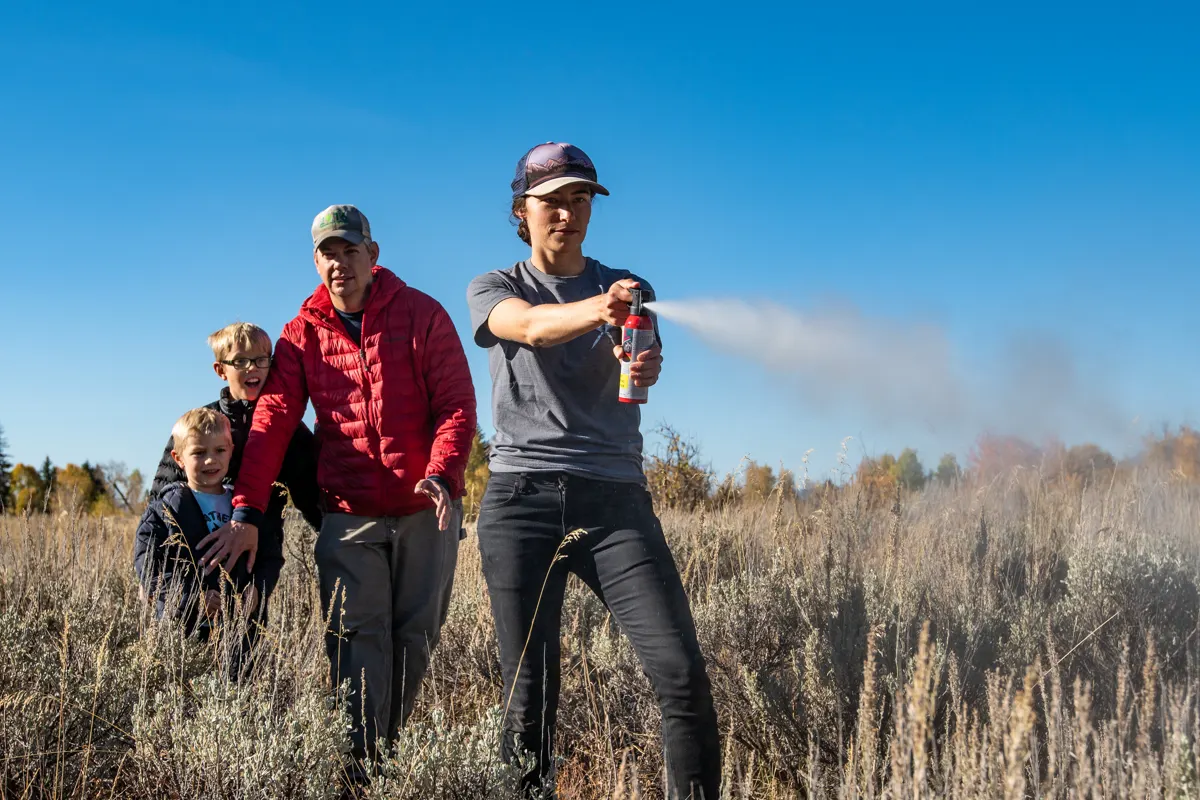 Ranger demonstrating bear spray with a family in Grand Teton National Park