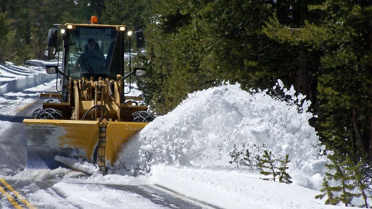 Deep snow beside a cleared high-country road during Yosemite spring opening work - Yosemite National Park | KnowOutdoor