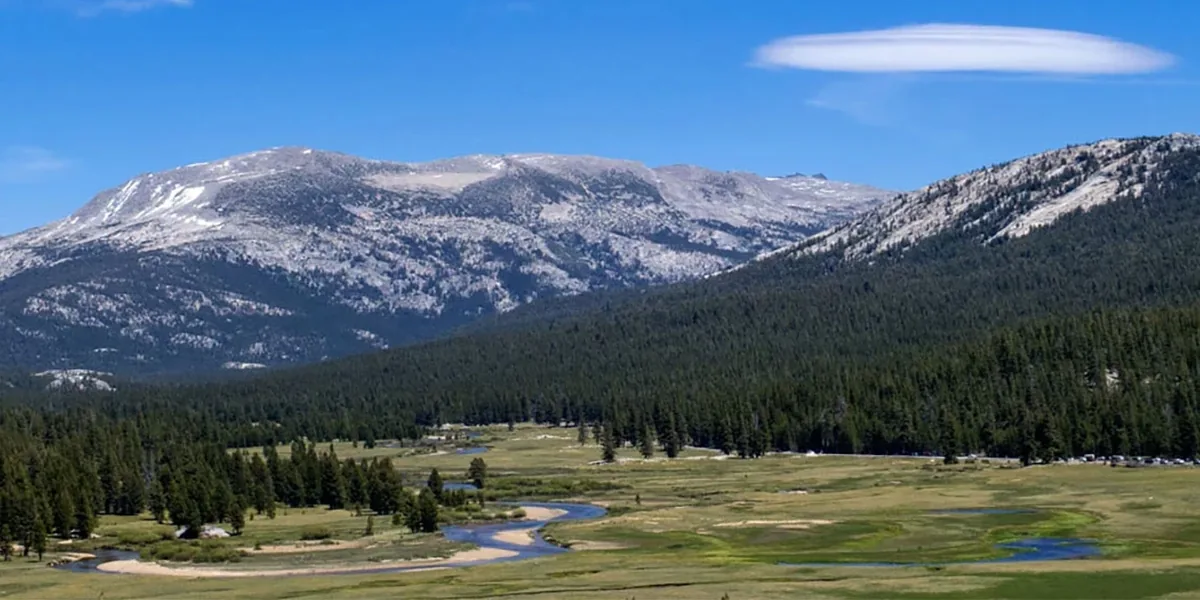 Hikers crossing open granite and meadow terrain in Yosemite's Tuolumne high country - Yosemite National Park | KnowOutdoor