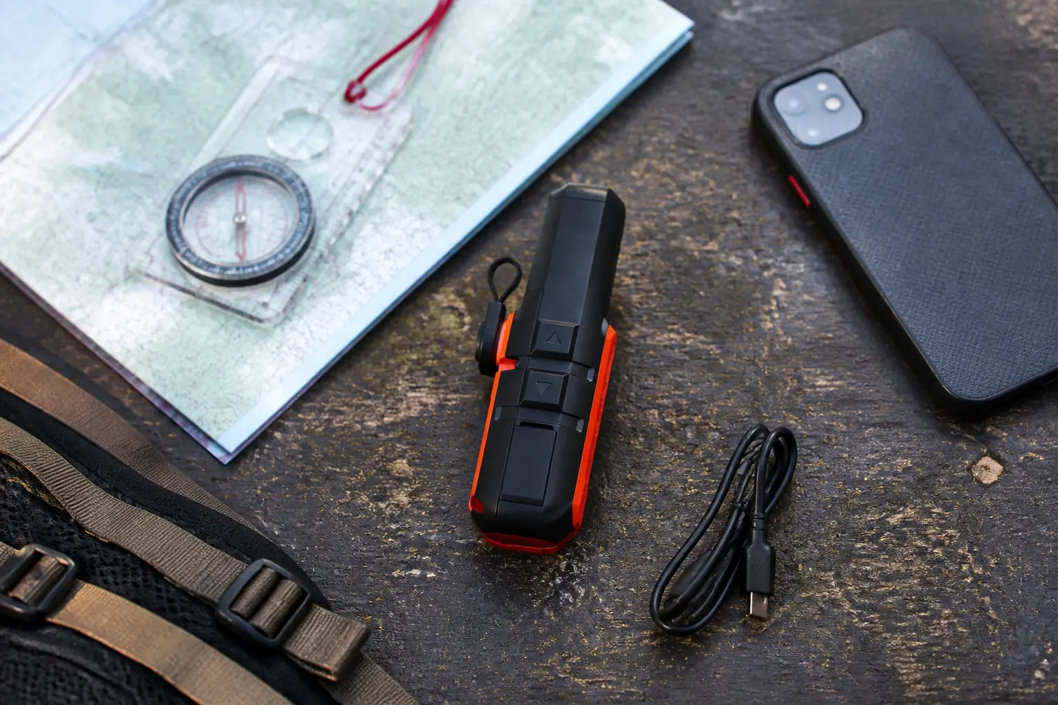 Garmin inReach Mini 2 with paper map compass phone cable and backpack clip on a field table | KnowOutdoor