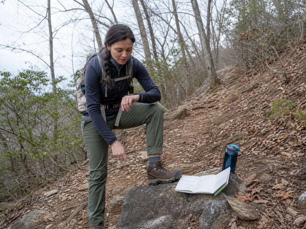 Hiker checking elapsed time foot comfort water and route progress during a rehearsal hike - hiking fitness test | KnowOutdoor