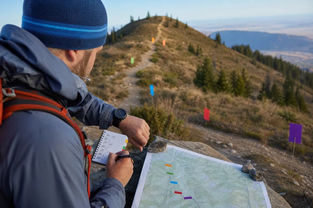 Hiker recording moving time, stopped time, climb, descent, rough-ground, and final-mile splits on a familiar route