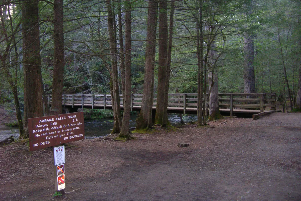 Abrams Falls Trailhead sign at the forest entrance in Cades Cove