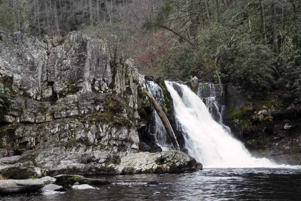 Abrams Falls flowing between ice-covered rocks in winter
